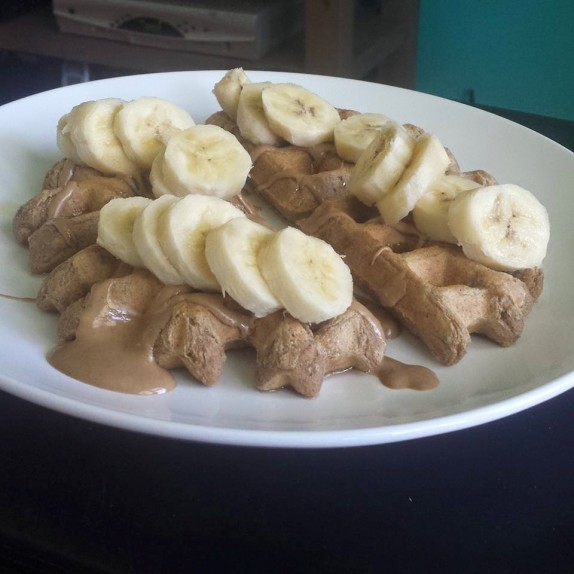 Protein waffle with sliced banana, D's Naturals Vanilla Maple Fluffbutter, and a drizzle of maple syrup